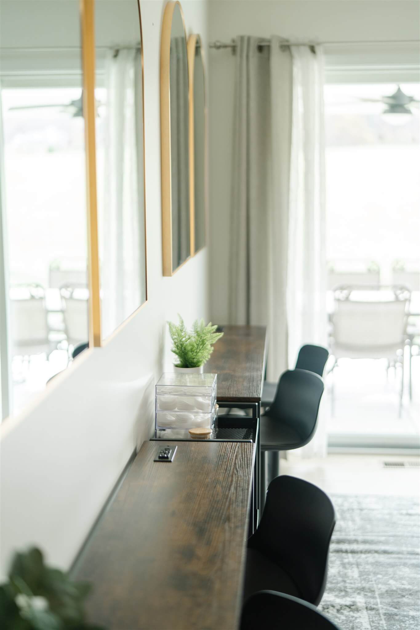 Beauty counter with stools facing large windows
